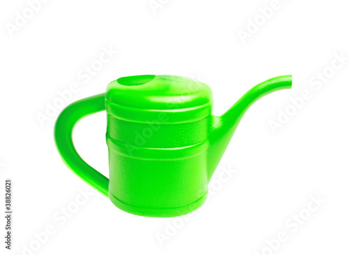 Green plastic watering can isolated on white
