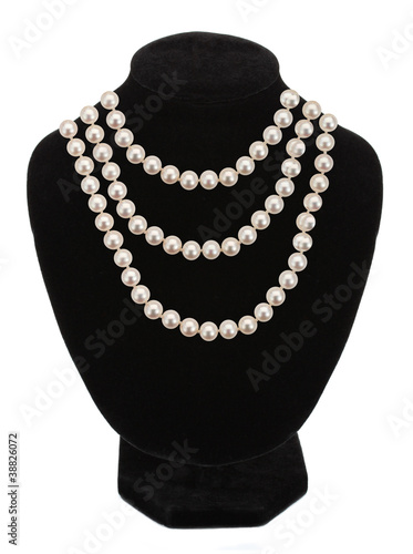 Pearl necklace on black mannequin isolated on white background