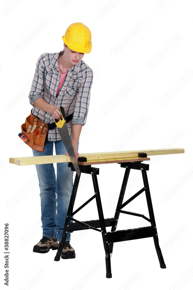 Handywoman cutting a plank Handywoman cutting a plank