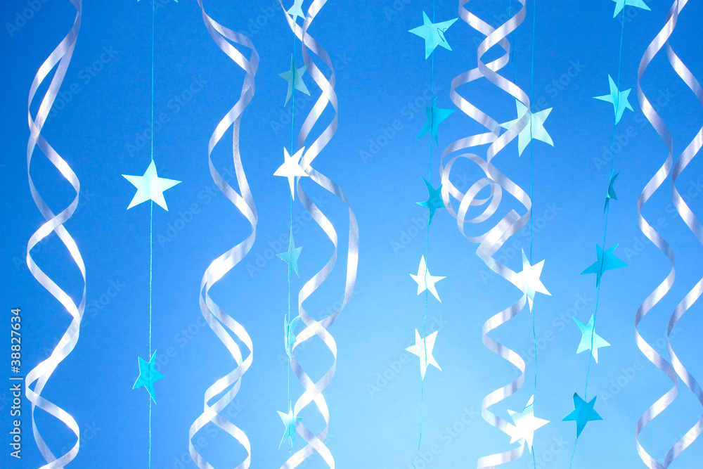 beautiful streamers and stars on blue background beautiful streamers and stars on blue background