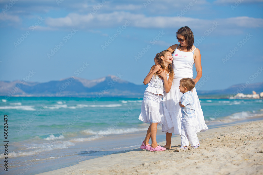 Young mother with her two kids on beach vacation