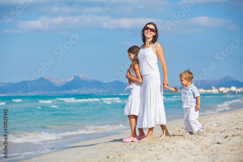 Young mother with her two kids on beach vacation © Max Topchii