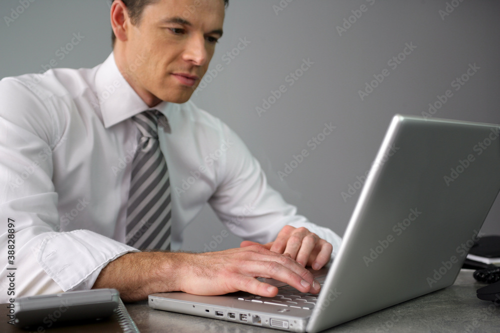 Man working away at his desk Man working away at his desk