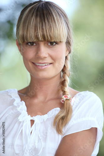 Fototapeta Naklejka Na Ścianę i Meble -  Portrait of a pretty blonde woman with a blunt fringe