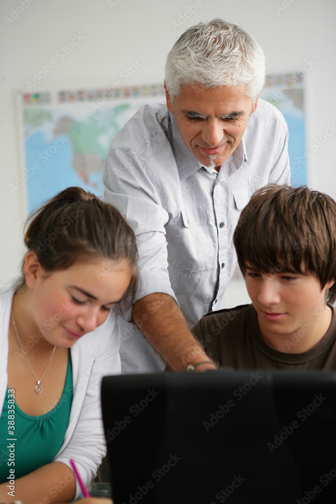 Obraz premium teacher and pupils in class