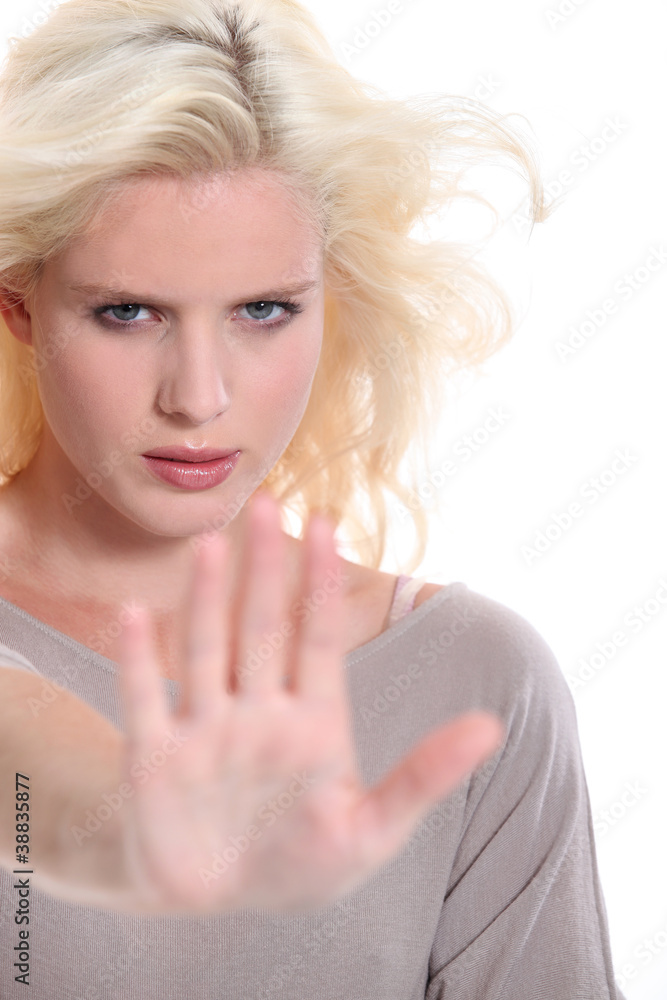 Woman holding out her hand in a stop signal Woman holding out her hand in a stop signal