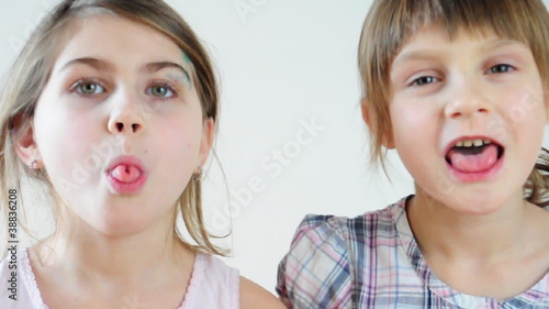 Two happy playful children laughing and making faces