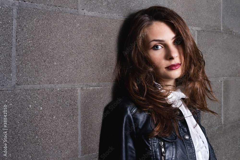 Tranquil beautiful woman against brick wall background Tranquil beautiful woman against brick wall background