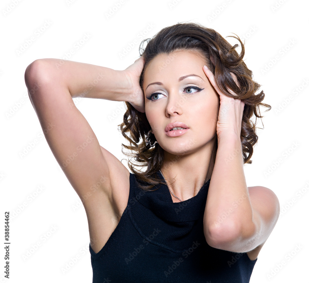 Obraz premium Portrait of a sexy woman touching herbeautiful curly hair