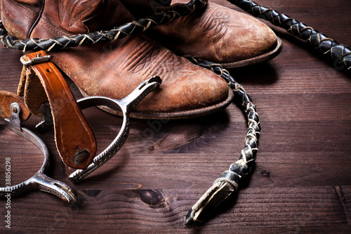 Canvas Print Cowboy boots,whip and spurs on wood