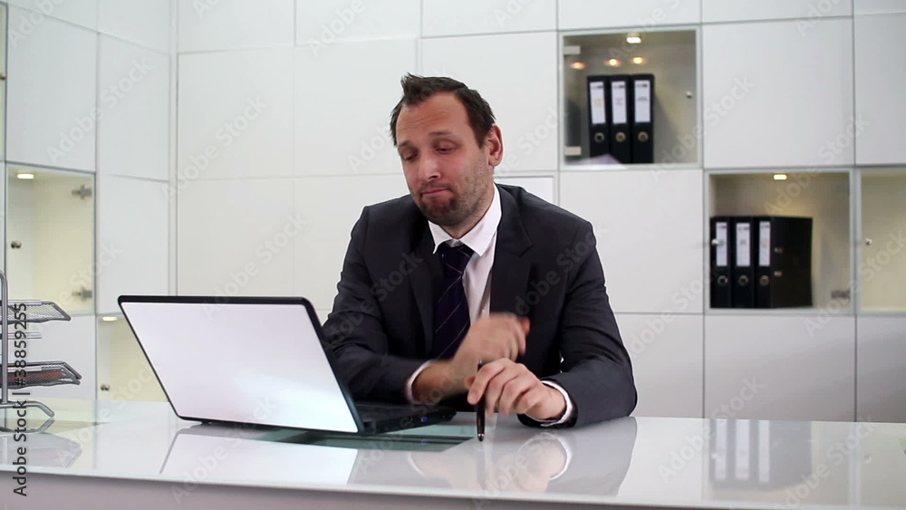Young bored businessman sitting in the office Young bored businessman sitting in the office