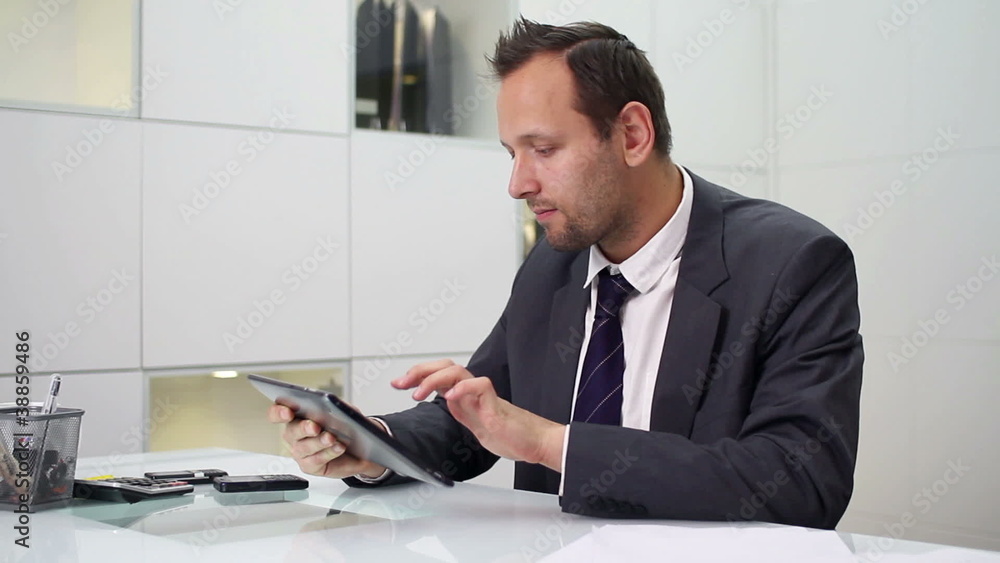 Young businessman with tablet computer in modern office Young businessman with tablet computer in modern office