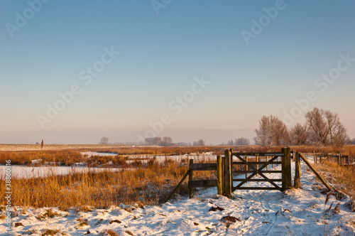 Wooden fence in a snowy Dutch landscape