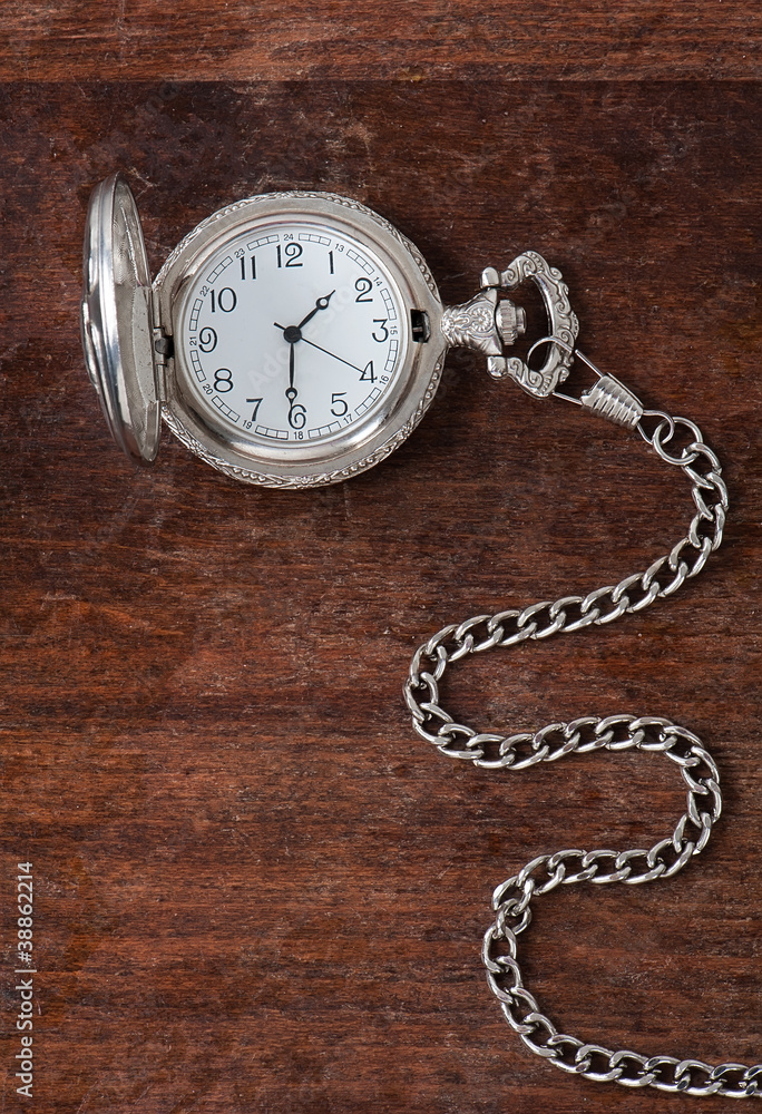 The old clock on a wooden surface The old clock on a wooden surface