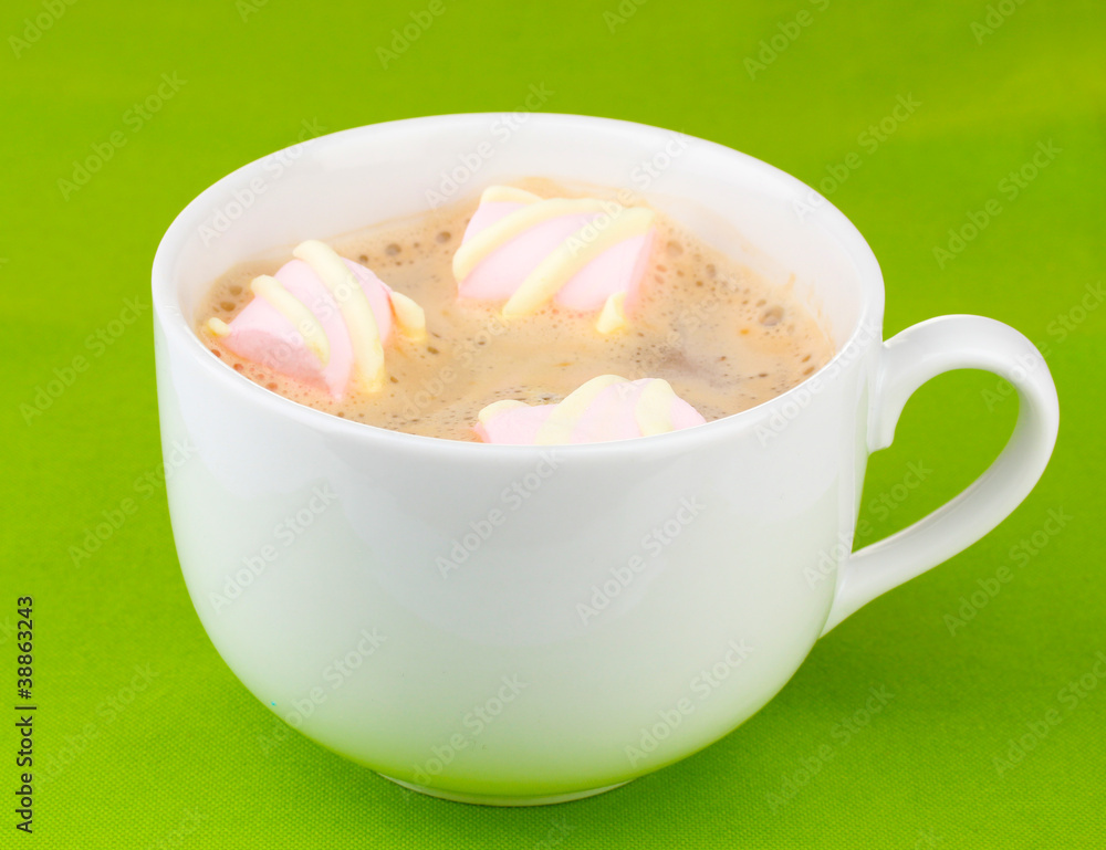 Cup of cappucino with marshmallows on green background Cup of cappucino with marshmallows on green background