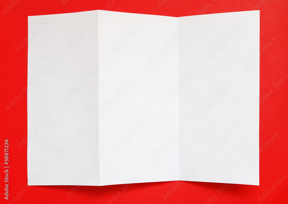 Folded paper on red background