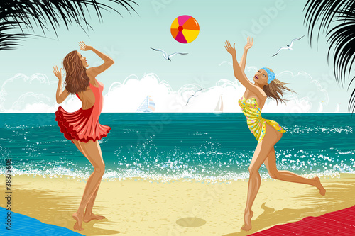 Two girls playing a ball at a beach