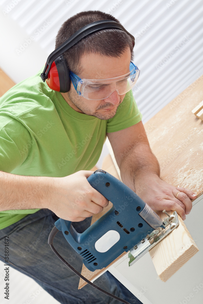Cutting wood with electric saw Cutting wood with electric saw