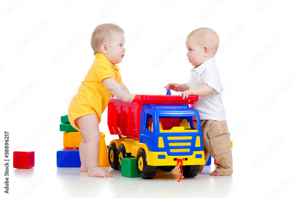 two little children playing with color toys and truck two little children playing with color toys and truck