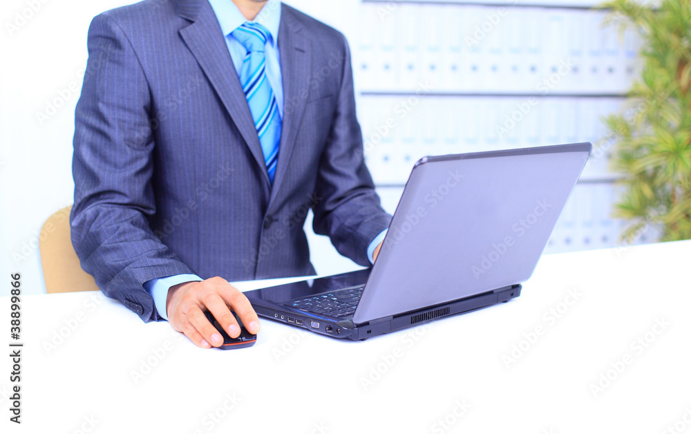 Male hand on mouse while working on laptop Male hand on mouse while working on laptop