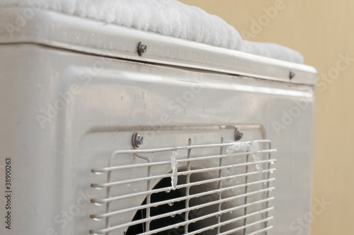 air conditioner covered by snow