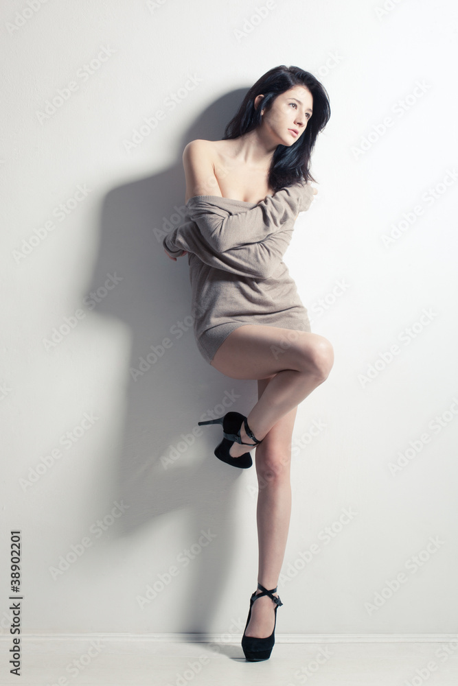 sexy woman posing at studio near wall sexy woman posing at studio near wall