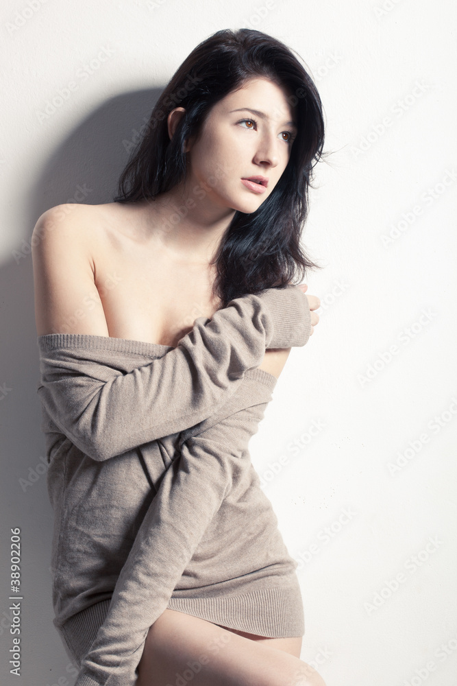 young woman posing at studio near wall young woman posing at studio near wall