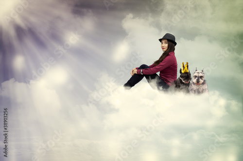 Young woman sitting on the cloud with dogs