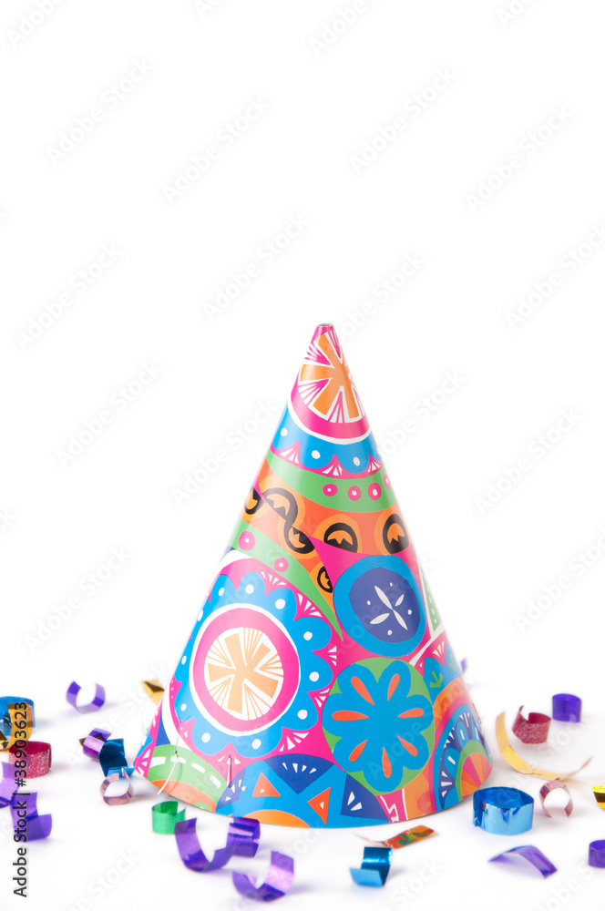 Bright party hat and confetti, isolated over white
