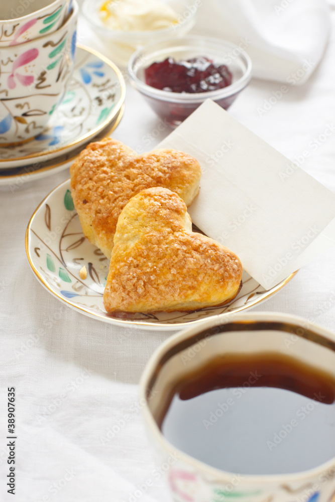 Romantic breakfast with tea, jam, butter and scones Romantic breakfast with tea, jam, butter and scones