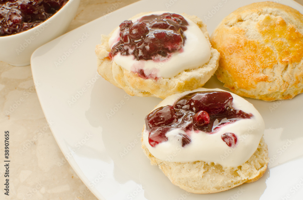 Scones with whipped cream and blackcurrant jam Scones with whipped cream and blackcurrant jam