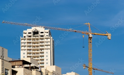 Lifting crane and apartment building under construction
