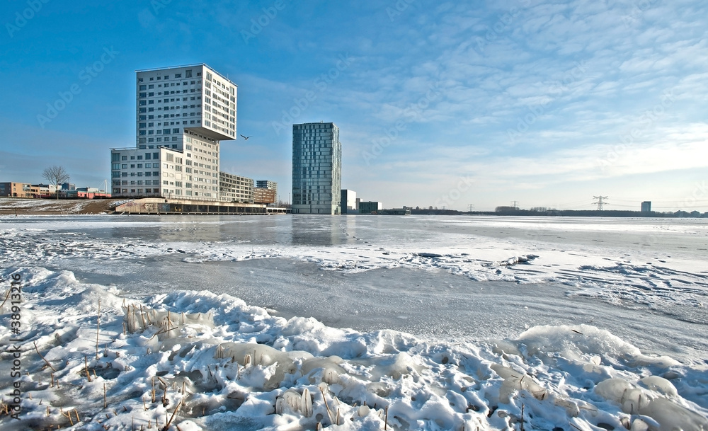 Apartments along a frozen lake in winter