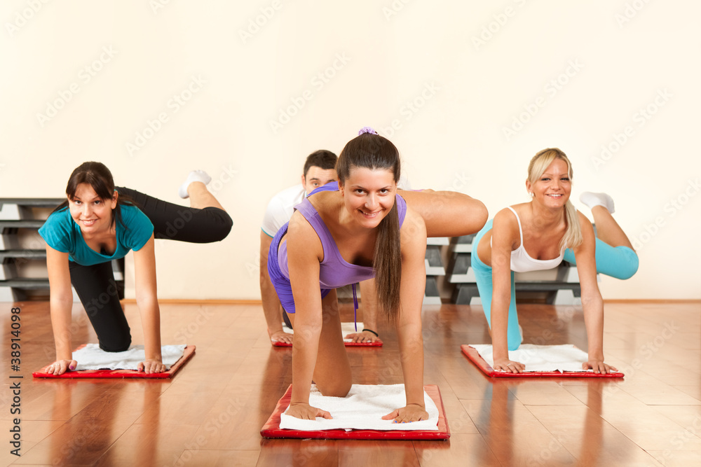 Naklejka premium four people is doing exercises in fitness club