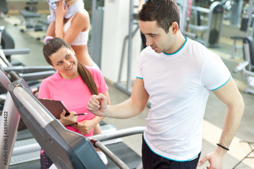 female trainer with man on treadmill female trainer with man on treadmill
