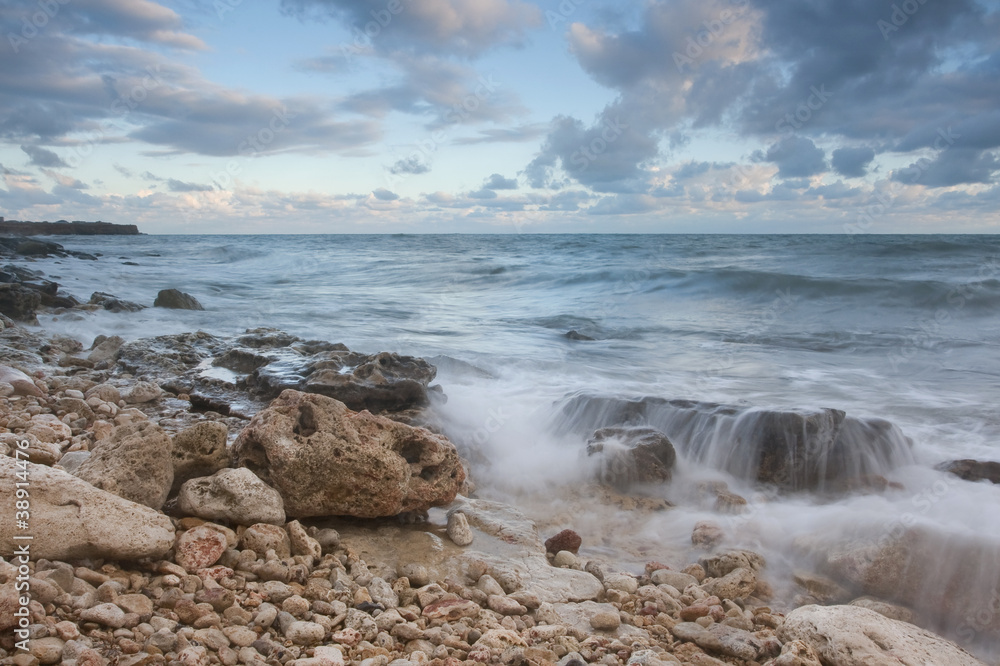 Beautiful rocky sea beach at the sunset Beautiful rocky sea beach at the sunset