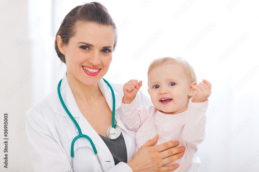 Portrait of pediatrician doctor with smiling baby Portrait of pediatrician doctor with smiling baby