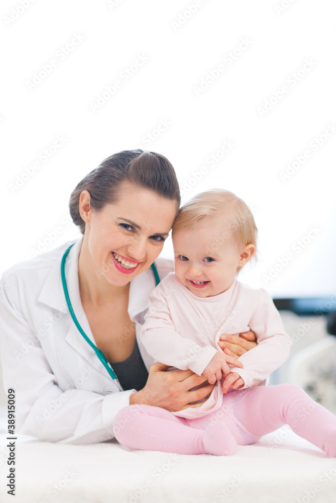 Portrait of laughing pediatrician doctor and baby Portrait of laughing pediatrician doctor and baby