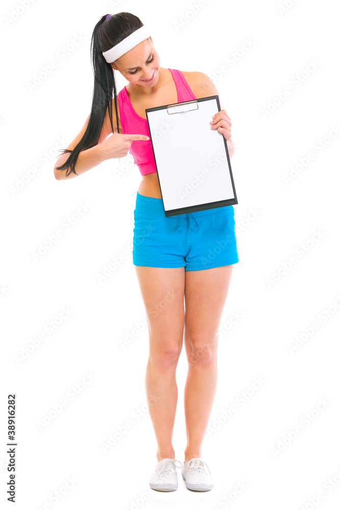 Fitness girl pointing on blank clipboard Fitness girl pointing on blank clipboard