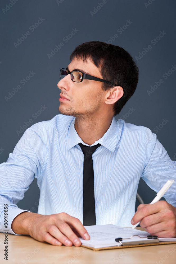 Business man sitting in the office and signing documents Business man sitting in the office and signing documents