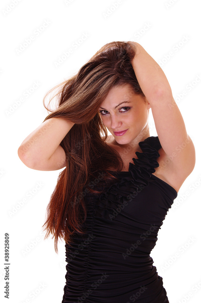 The woman in black dress straightens hair The woman in black dress straightens hair