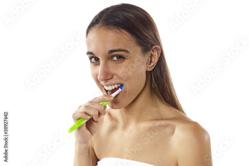 Young woman brushing teeth staying healthy