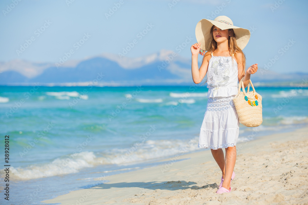 Adorable girl wearing elegant hat on the beach Adorable girl wearing elegant hat on the beach