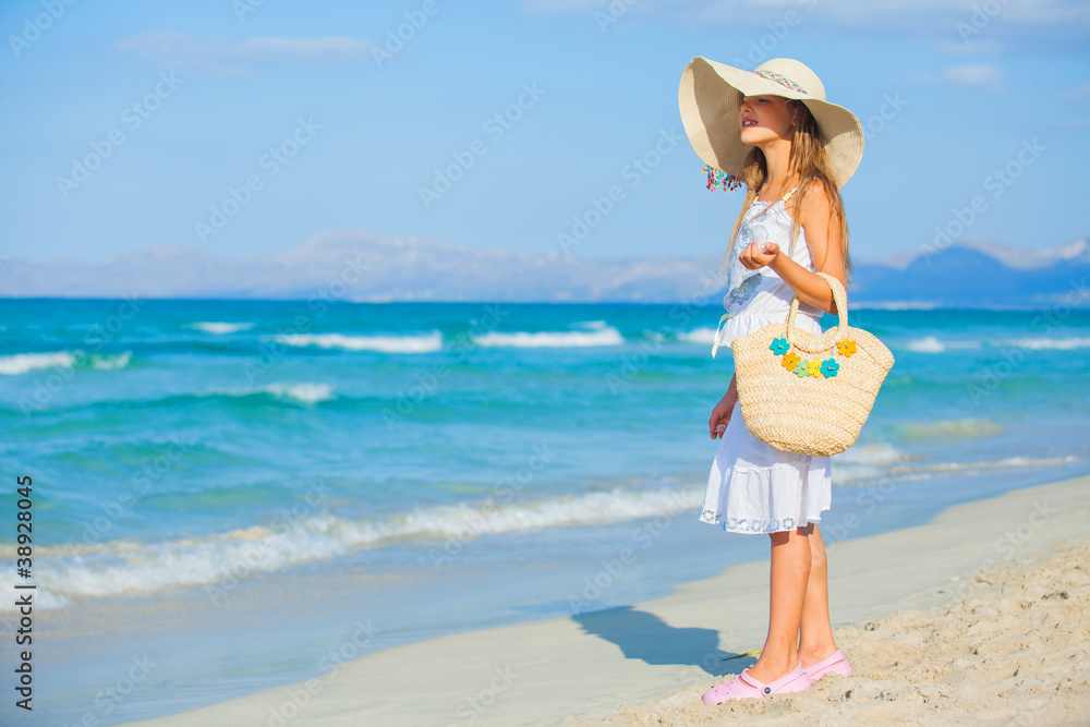Adorable girl wearing elegant hat on the beach Adorable girl wearing elegant hat on the beach