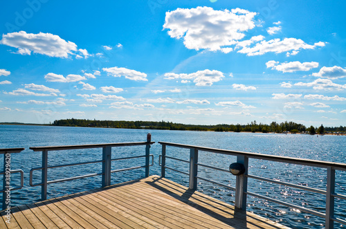 lake pier against the blue sky, angled view