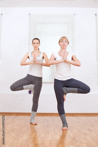 Women doing yoga exercise at gym