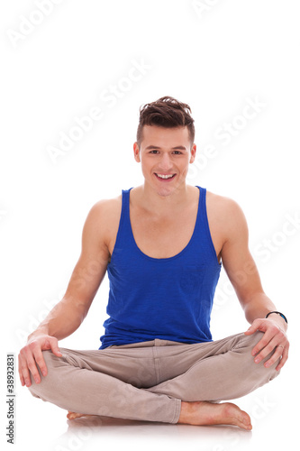 young barefoot man in a yoga position