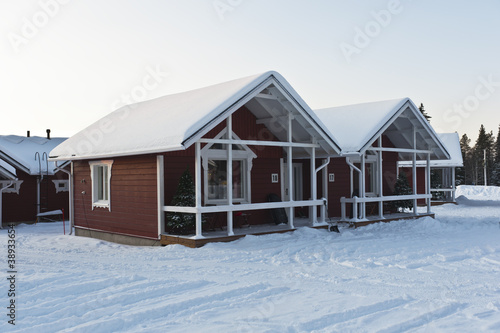 wooden house in Lapland in winter landscape