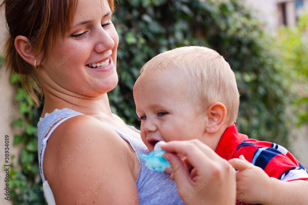 Happy young woman and toddler boy outdoors Happy young woman and toddler boy outdoors