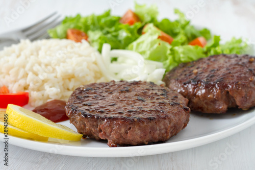 grilled hamburger with rice and salad